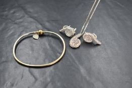 A silver cubic zirconia set necklace and earrings set, in a spiral motif, marked 925, along with a