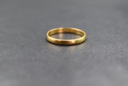 A 22ct gold band, of thin plain form, marked 22 with hallmarks, ring size L-M, 2.1g