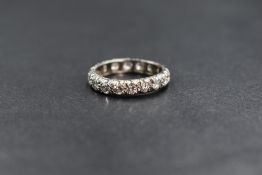 A white metal diamond set full eternity band, the round brilliant cut diamonds measuring