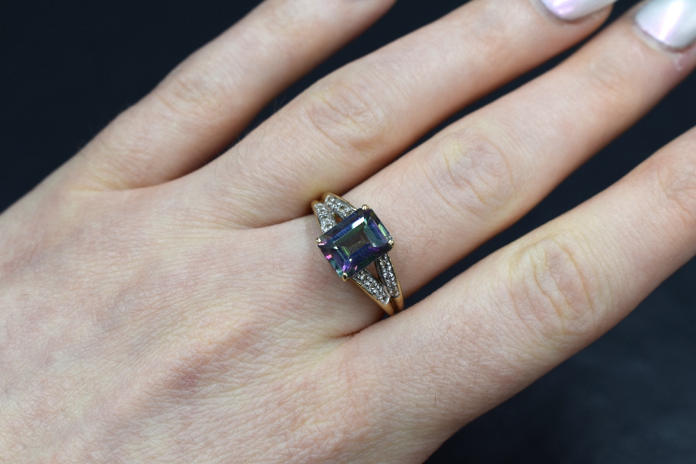 A 9ct gold mystic topaz ring having a single emerald cut stone in a four claw set mount to split gem - Image 3 of 3