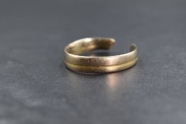 An 18ct gold two tone band, the white gold band having a yellow gold channel decoration, the band