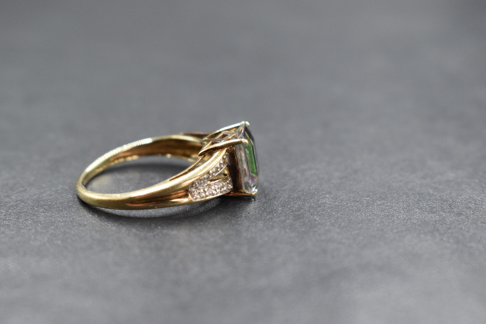 A 9ct gold mystic topaz ring having a single emerald cut stone in a four claw set mount to split gem - Image 2 of 3