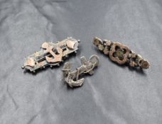 Three Victorian silver and white metal brooches, two having anchors and one of floral design, one