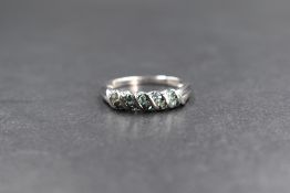 A 9ct white gold band ring having ten inset green stones, possibly fluorite, size N & 2.2g
