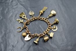 A 9ct gold curb link charm bracelet, having a heart padlock and twelve gold and yellow metal