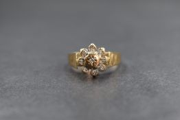 A 9ct gold diamond set cluster ring, the central diamond in an eight illusion diamond chip set