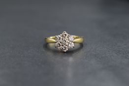 An 18ct gold daisy cluster ring, having seven brilliant cut diamonds, approx 0.85ct total in a
