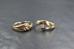 A 14ct two tone diamond set ring, the round brilliant cut diamond, measuring approximately 0.15ct,