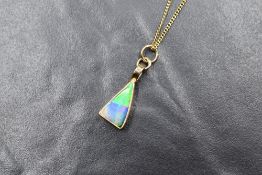 A 14ct gold boulder opal pendant, of triangular form in a bezel setting, marked 585, on an 18ct gold