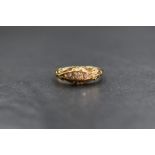 An 18ct gold diamond set five stone ring, the five graduated old cut diamonds, in a channel style