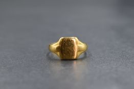 A 22ct gold signet ring, the rectangular panel of plain form having moulded shoulders, marked 22
