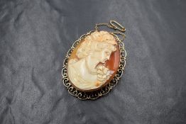A large 9ct gold mounted cameo brooch, the cameo depicting a maiden in profile, in a bezel setting