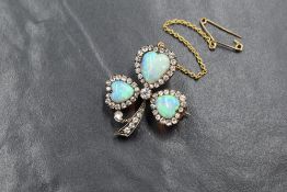 A yellow metal presumed gold opal and diamond set clover motif brooch, the three graduated opals
