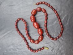 A 'cherry amber' style bakelite beaded necklace, the graduated beads on a yellow metal clasp