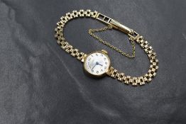 A 9ct gold Roamer wristwatch, the silvered dial having Arabic numerals, on a 9ct gold bracelet
