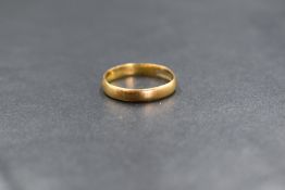 A 22ct gold band, of plain rounded form, marked 22 with hallmarks, ring size M, 2.4g