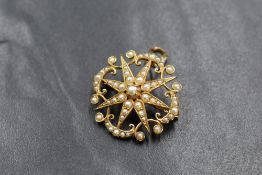 A 15ct gold seed pearl set star brooch/pendant, the central seed pearl set star within a seed