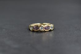 A 9ct gold amethyst and topaz set band, the three round cut pale blue topaz alternating with two