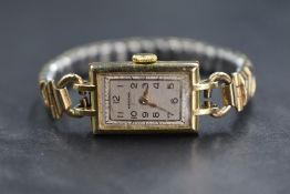 A 9ct gold Orator Swiss wristwatch, the rectangular champagne dial having Arabic numerals, marked