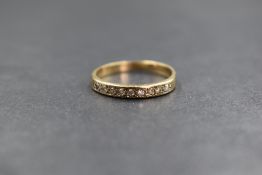 A 9ct gold diamond set band, the band set with 9ct round brilliant cut diamonds, marked 375, ring