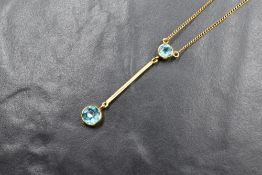 A 9ct gold paste set pendant, the round cut blue paste in a bezel setting, having an articulated bar