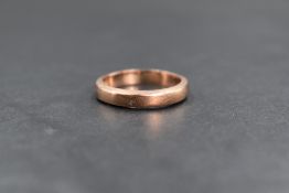 A 9ct rose gold band, of plain rounded form, marked 375, ring size M, 3.6g