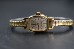 A ladies vintage yellow metal wrist watch by Winegartens of London having a baton numeral dial to