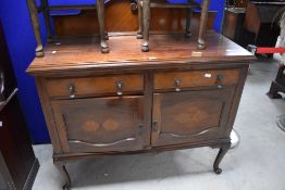 An early 20th century mahogany sideboard, having a raised and shaped back over the moulded