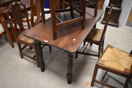 A Victorian stained pine kitchen table, having a rectangular top raised on block and turned
