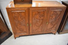 A Chinese carved hardwoodsideboard, having typical carved chinoiserie decoration, dimensions approx.