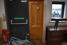 A modern pine single hall robe, with double panelled door, on turned feet 188cm x 54cm x 53cm