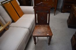 A late Victorian mahogany hall chair (seat worn and frame a little loose)