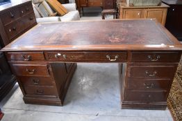 A large early 20th century mahogany pedestal knee hole desk, the rectangular moulded top with