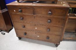 A 19th century oak chest of drawers, the rectangular top above two short and three long cockbeaded