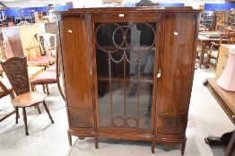 An attractive Edwardian inlaid mahogany display cabinet, the shaped oblong top with slender raised