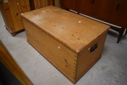 An early/mid 20th century pine blanket box, of traditional design, the rectangular top opening on