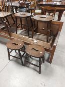 A group of four elm seated stools, the oval seated with shaped central cut-out 'handle' over