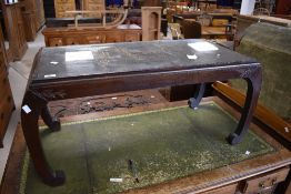 A 20th century Chinese carved hardwood coffee table, the rectangular top carved in relief with