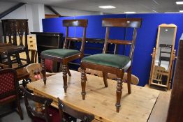 A pair of Victorian mahogany rail-back dining chairs with plain curved top and mid-rails over the