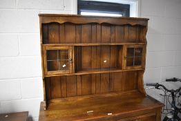 A modern reproduction oak dresser and rack, of traditional design 173cm x 120cm x 44cm