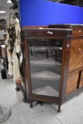 An early 20th century glazed mahogany corner display cabinet, with four internal shelves, long