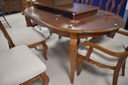 A good quality modern reproduction mahogany extending dining table and six (four + two) dining