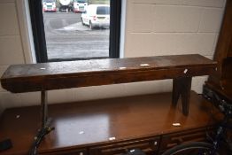 A traditional stained pine form/bench with single plank seat and rudimentary legs, 43cm x 37cm x