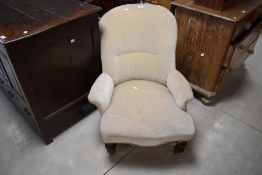 A Victorian upholstered nursing chair, with turned front supports, seat height 34cm, 76cm overall.
