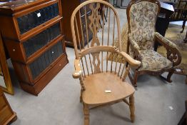 A 20th century reproduction Windsor design armchair, with typical arched back, central shaped and