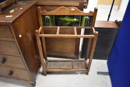 An early 20th century Arts & Crafts style stick/umbrella stand, the double arched back with inset