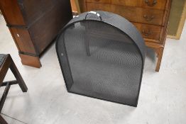 A modern arched and black painted metal spark guard, with arched handle 82cm x 63cm x 13cm