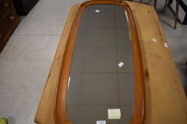 A good 1970's Danish teak framed bevelled mirror, of rounded oblong form, the reverse marked Made in