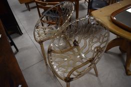 An attracive and unusual set of six smoked transparent polycarbonate tree design dining chairs, of