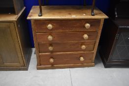 An early 20th century pine chest of four drawers, the rectangular top with chamfered edge detail